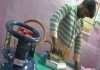 Man irons clothes using cooking gas